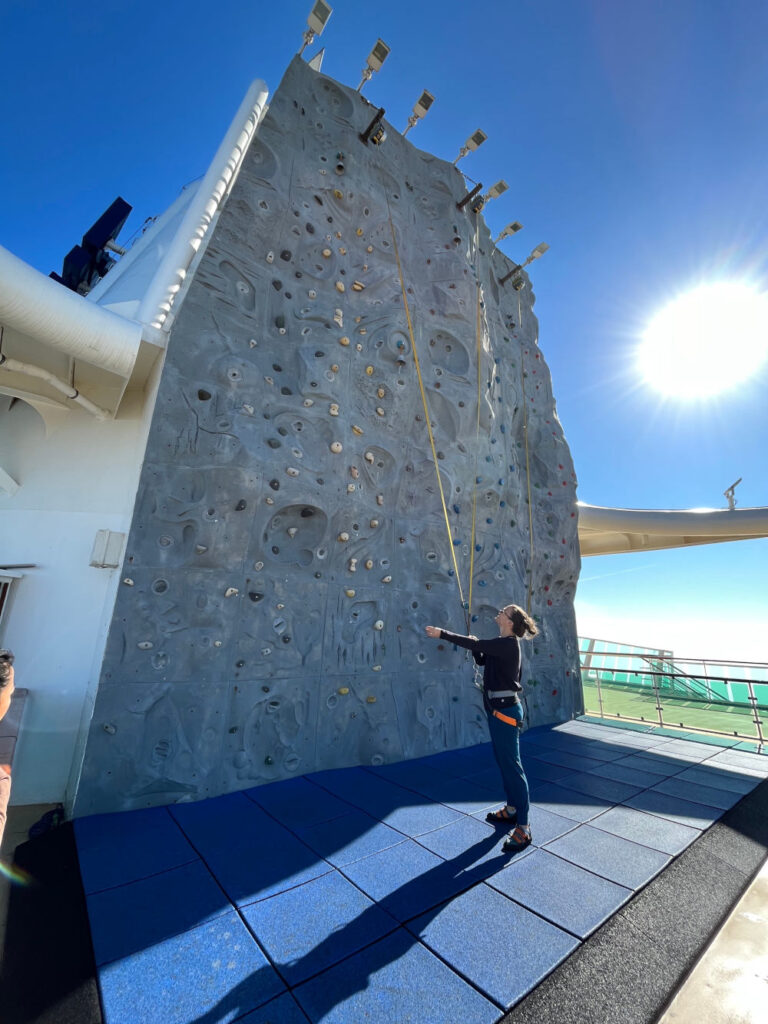 Guest looking up at the rock climbing wall on Royal Caribbean cruise ship